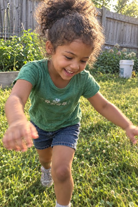Example photo: Maya running across her backyard